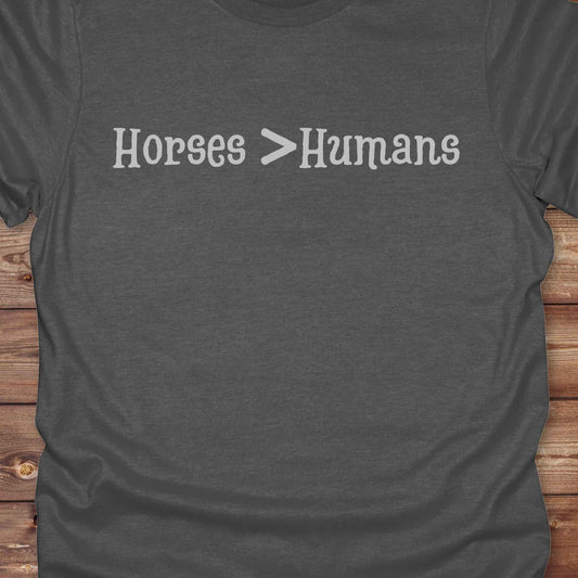 Show off your equestrian spirit with our “Horses > Humans” western t-shirt — made for horse lovers with a sense of humor. This minimal black design says it all: horses are better than people, period. Perfect for cowgirls, cowboys, equestrians, rodeo fans, and sarcastic ranch folk who know where their loyalty lies. Whether you're gifting it to a horse girl or repping it at a rodeo, this tee delivers comfort, country attitude, and all the sass. 