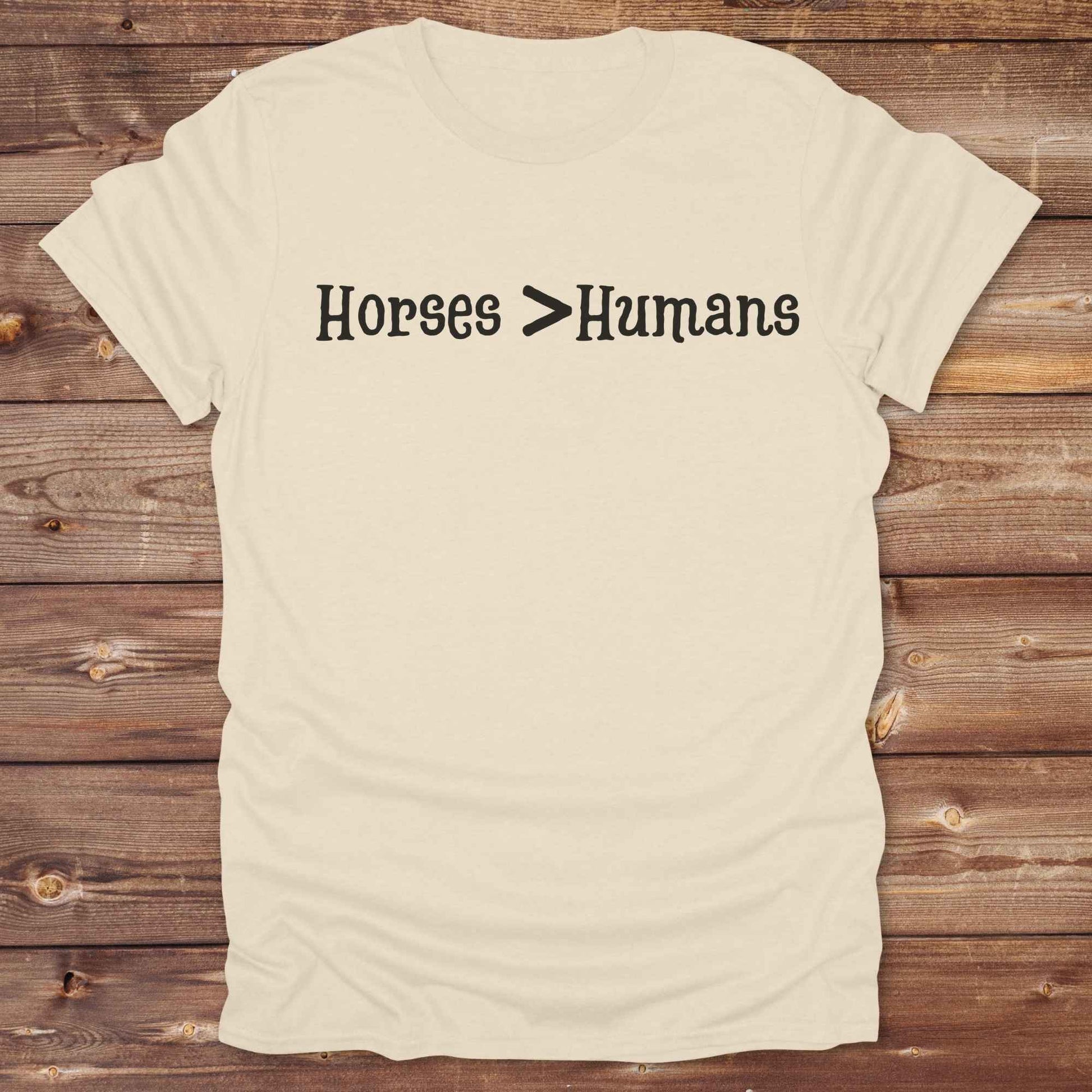 Show off your equestrian spirit with our “Horses > Humans” western t-shirt — made for horse lovers with a sense of humor. This minimal black design says it all: horses are better than people, period. Perfect for cowgirls, cowboys, equestrians, rodeo fans, and sarcastic ranch folk who know where their loyalty lies. Whether you're gifting it to a horse girl or repping it at a rodeo, this tee delivers comfort, country attitude, and all the sass. 