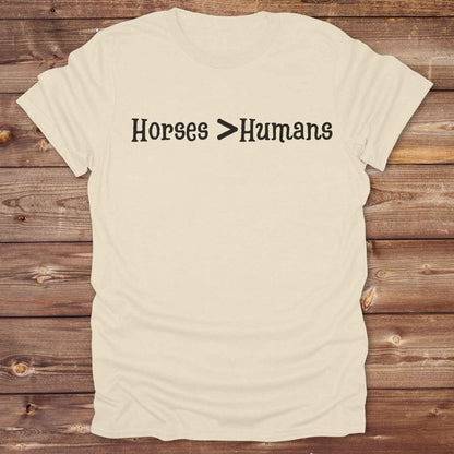 Show off your equestrian spirit with our “Horses > Humans” western t-shirt — made for horse lovers with a sense of humor. This minimal black design says it all: horses are better than people, period. Perfect for cowgirls, cowboys, equestrians, rodeo fans, and sarcastic ranch folk who know where their loyalty lies. Whether you're gifting it to a horse girl or repping it at a rodeo, this tee delivers comfort, country attitude, and all the sass. 