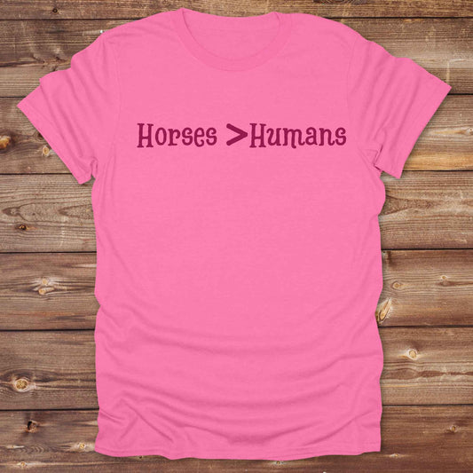 Show off your equestrian spirit with our “Horses > Humans” western t-shirt — made for horse lovers with a sense of humor. This minimal black design says it all: horses are better than people, period. Perfect for cowgirls, cowboys, equestrians, rodeo fans, and sarcastic ranch folk who know where their loyalty lies. Whether you're gifting it to a horse girl or repping it at a rodeo, this tee delivers comfort, country attitude, and all the sass. 