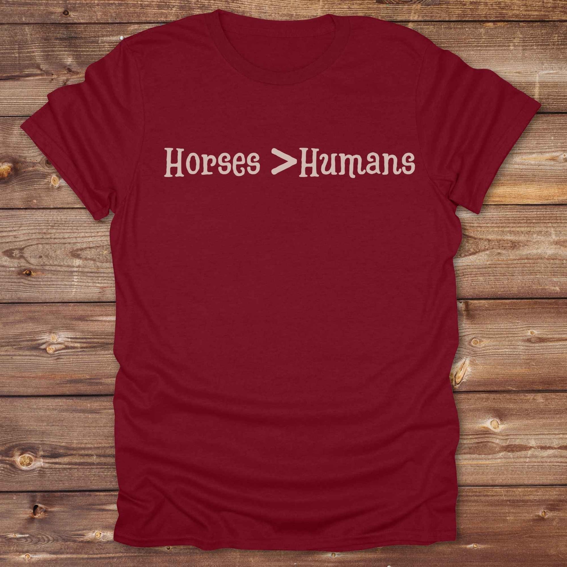 Show off your equestrian spirit with our “Horses > Humans” western t-shirt — made for horse lovers with a sense of humor. This minimal black design says it all: horses are better than people, period. Perfect for cowgirls, cowboys, equestrians, rodeo fans, and sarcastic ranch folk who know where their loyalty lies. Whether you're gifting it to a horse girl or repping it at a rodeo, this tee delivers comfort, country attitude, and all the sass. 