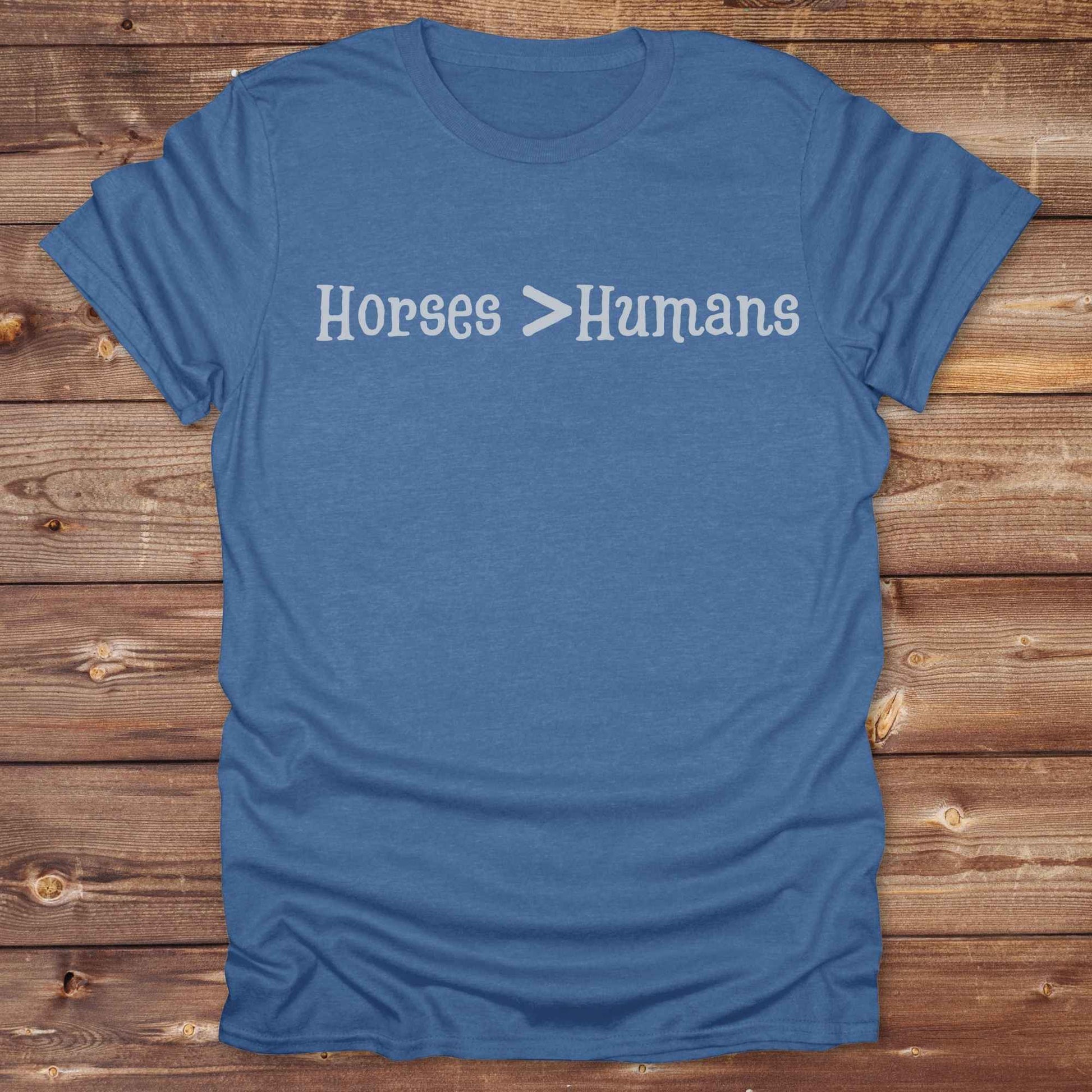 Show off your equestrian spirit with our “Horses > Humans” western t-shirt — made for horse lovers with a sense of humor. This minimal black design says it all: horses are better than people, period. Perfect for cowgirls, cowboys, equestrians, rodeo fans, and sarcastic ranch folk who know where their loyalty lies. Whether you're gifting it to a horse girl or repping it at a rodeo, this tee delivers comfort, country attitude, and all the sass. 