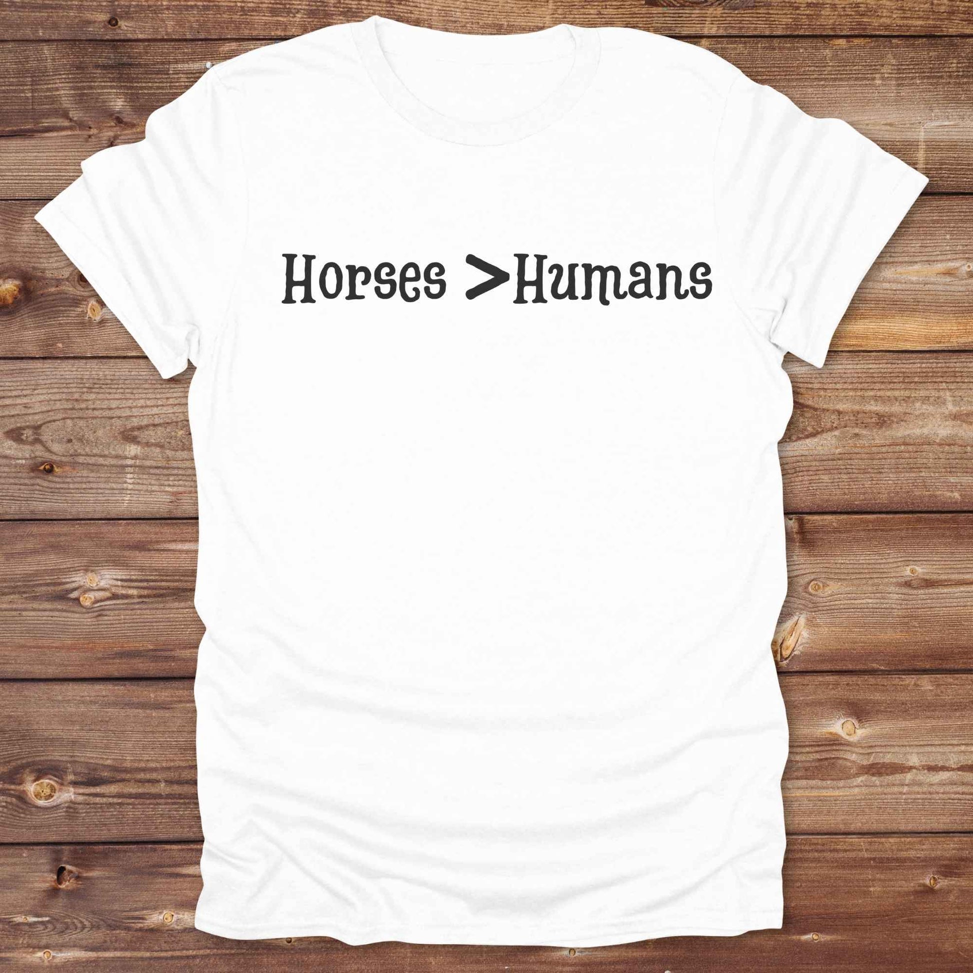 Show off your equestrian spirit with our “Horses > Humans” western t-shirt — made for horse lovers with a sense of humor. This minimal black design says it all: horses are better than people, period. Perfect for cowgirls, cowboys, equestrians, rodeo fans, and sarcastic ranch folk who know where their loyalty lies. Whether you're gifting it to a horse girl or repping it at a rodeo, this tee delivers comfort, country attitude, and all the sass. 
