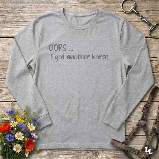 A light gray long-sleeve t-shirt with the text 'OOPS ... I got another horse'