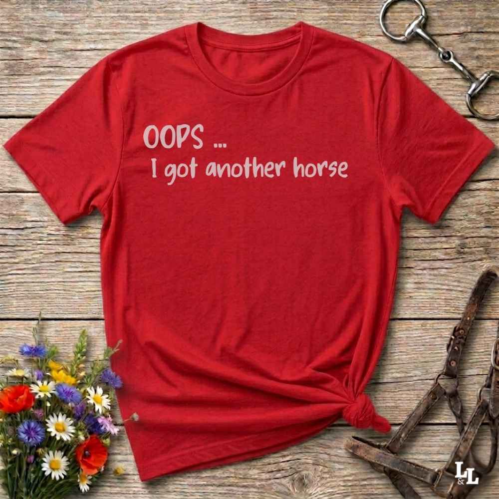 A red short-sleeve t-shirt with the white text 'OOPS .... I got another horse'