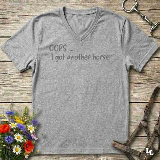 A heather gray V-neck t-shirt with the text 'OOPS.