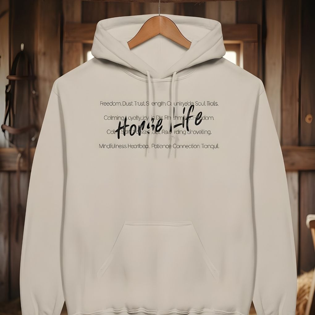 Beige hoodie with text on a wooden hanger against a rustic wooden background. Horse Life Words Hoodie for Horse Lovers, Barn Apparel for Riders