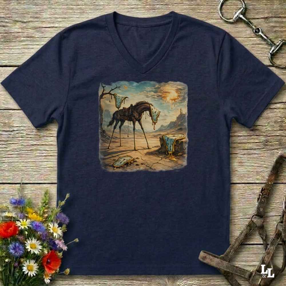 A navy blue V-neck t-shirt with a surreal graphic print of a skeletal horse standing in a desert landscape, styled on a rustic wooden background with equestrian accessories and flowers.