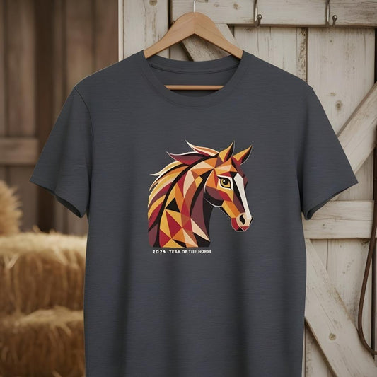 Dark gray t-shirt with a colorful horse graphic and '2024 Year of the Horse' text, hanging on a wooden hanger against a rustic wooden background.