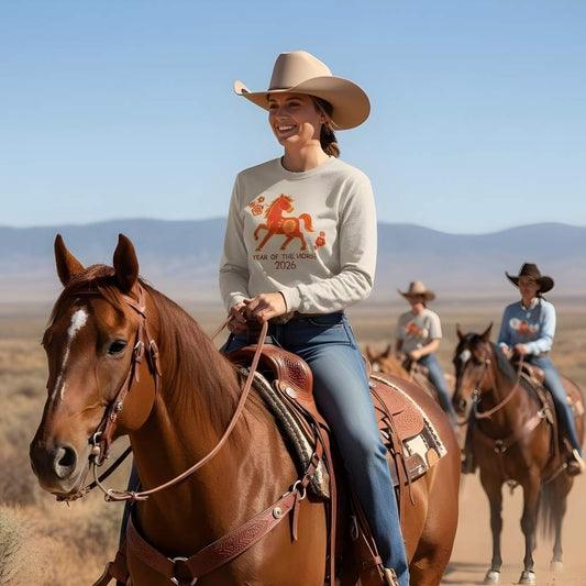 Woman riding a horse in a desert landscape with mountains in the background. Year of the Horse Long Sleeve Tee for Horse Lovers, Equestrian Riding Wear