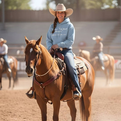 Woman riding a horse in a rodeo arena with other riders in the background. Never Too Many Hoodie for Horse Lovers, Trail Riding Hoodie, Riding Apparel