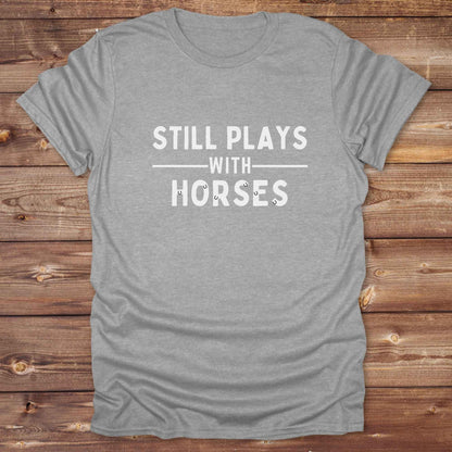 Fun western t-shirt for horse lovers and cowgirls. Western cowgirl graphic tee with horse design. Cowboy humor t-shirt for rodeo and country lovers. Horse lover funny t-shirt with western theme. Country style horse graphic tee for cowboys and cowgirls. Retro style funny western shirt for equestrians. Cute and funny country shirt with horse print. Southern cowgirl funny quote shirt for horse lovers. Still plays with horses.