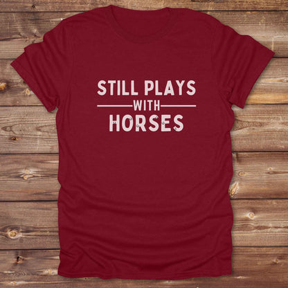 Fun western t-shirt for horse lovers and cowgirls. Western cowgirl graphic tee with horse design. Cowboy humor t-shirt for rodeo and country lovers. Horse lover funny t-shirt with western theme. Country style horse graphic tee for cowboys and cowgirls. Retro style funny western shirt for equestrians. Cute and funny country shirt with horse print. Southern cowgirl funny quote shirt for horse lovers. Still plays with horses.