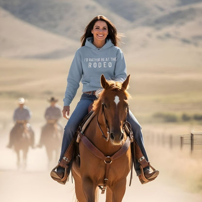 Woman riding a horse in a desert landscape wearing a hoodie with text. I'd Rather be at the Rodeo Hoodie for Horse Lovers, Trail Riding Hoodie, Equestrian Barn Wear for gifts