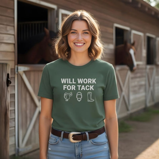 Woman wearing a green t-shirt with text standing in front of horse stables. Will Work for Tack T-Shirt Trail Riding Tee for Horse Riders, Equestrian Apparel