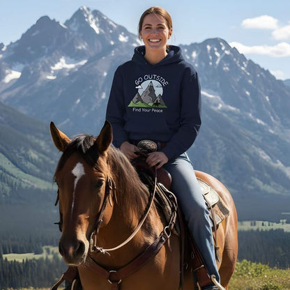 Woman riding a horse with mountains in the background wearing a hoodie with a mountain graphic. Go Outside Find your Peace Hoodie for Horse Lovers, Cozy Barn Wear, Trail Riding Hoodie