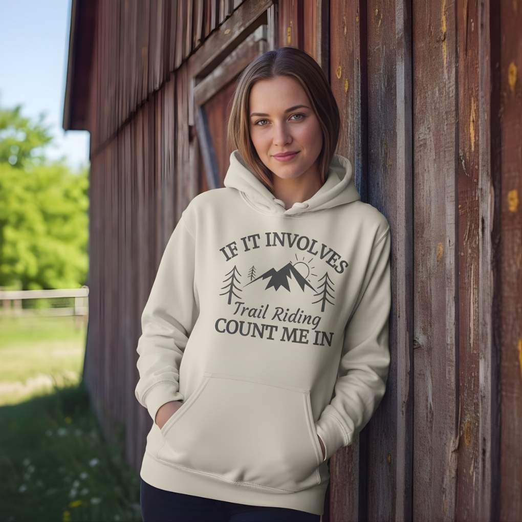 Woman wearing a hoodie with text and graphics, standing against a wooden wall. Count me In Hoodie for Horse Lovers, Trail Riding Tee for Horse Riders, Equestrian Apparel