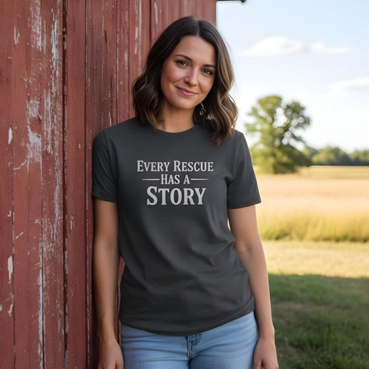 Woman wearing a t-shirt with 'Every Rescue Has a Story' text, standing in front of a red barn. Every Rescue has a Story T-Shirt for Horse Lovers, Trail Riding Tee