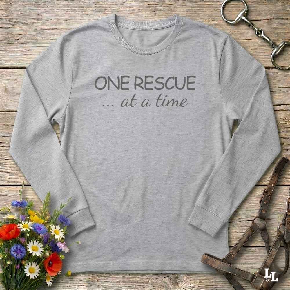 A light gray long-sleeve t-shirt with the text 'ONE RESCUE at a time'
