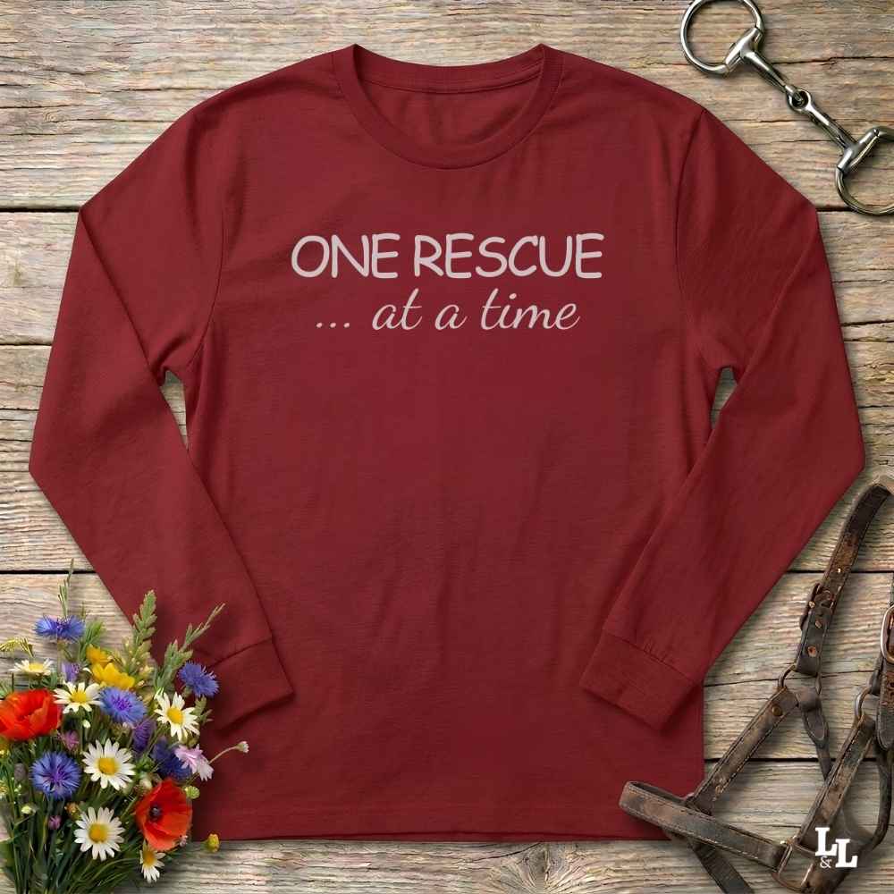 A red long-sleeve t-shirt with the text 'ONE RESCUE at a time'