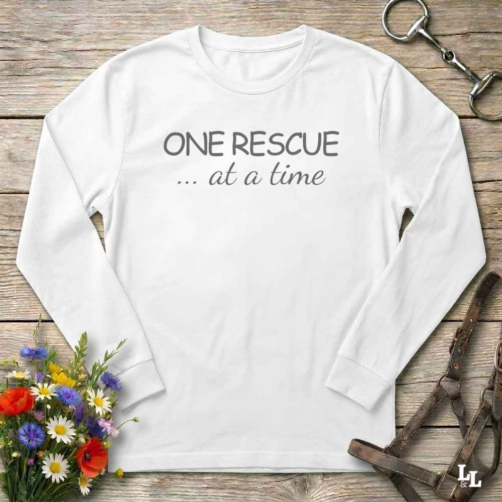 A white long-sleeve t-shirt with the text 'ONE RESCUE at at ime'