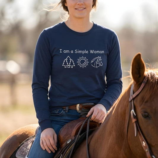 Woman riding a horse wearing a navy blue shirt with text and graphics. I am a Simple Woman Long Sleeve Tee for Horse Lovers, Equestrian Wear, Trail Riding Tee