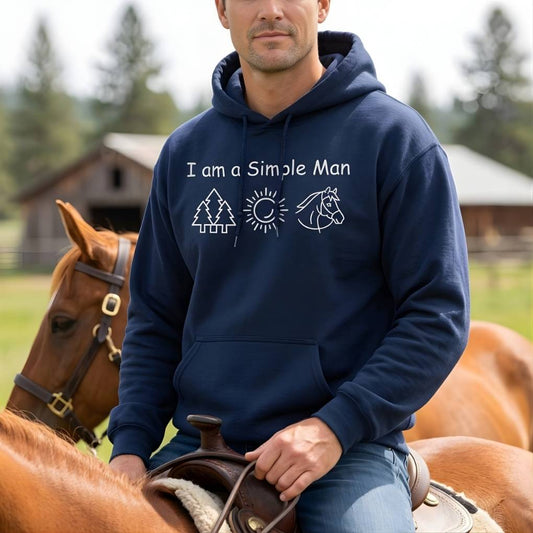 Man wearing a navy hoodie with a horse-related graphic and text, sitting on a horse in a rural setting. I am a Simple Man Hoodie for Horse Lovers, Trail Riding Hoodie Equestrian Apparel
