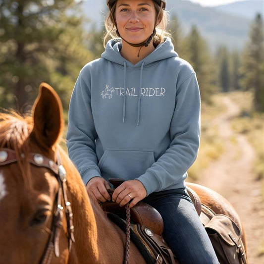 Person riding a horse wearing a 'Trail Rider' hoodie with a scenic . Trail Rider Hoodie for Horse Riders, Trail Riding Hoodie, Equestrian Wearbackground.
