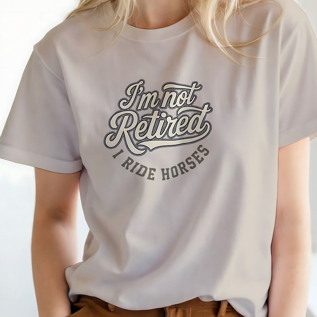 Person wearing a white t-shirt with text 'I'm not retired, I ride horses' on a plain background.  I'm Not Retired I Ride Horses T-Shirt For Horse Lovers, Trail Riding Tee, perfect gift for horse riders