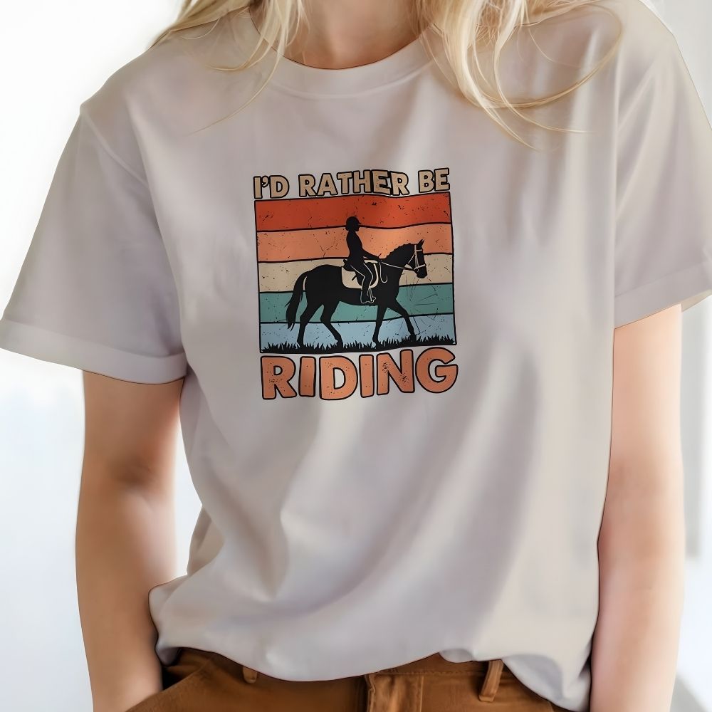 Person wearing a white t-shirt with a horse and rider graphic and text 'I'd Rather Be Riding'.  I'd Rather be Riding T-Shirt for Horse Riders, Trail Riding Tee, perfect gift for horse lovers