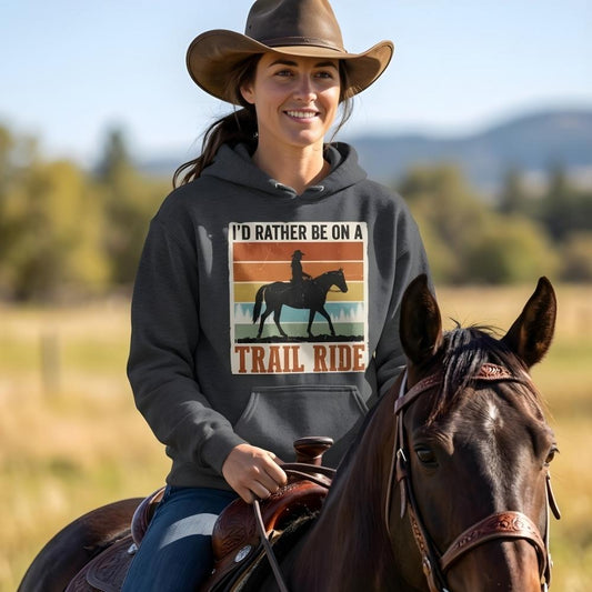 Woman on a horse wearing a hoodie with a trail riding graphic. I'd Rather be on a Trail Ride Hoodie for Horse Riders, Cozy Barn Wear for Trail Riding. Perfect gift for horse lover, Equestrian apparel.