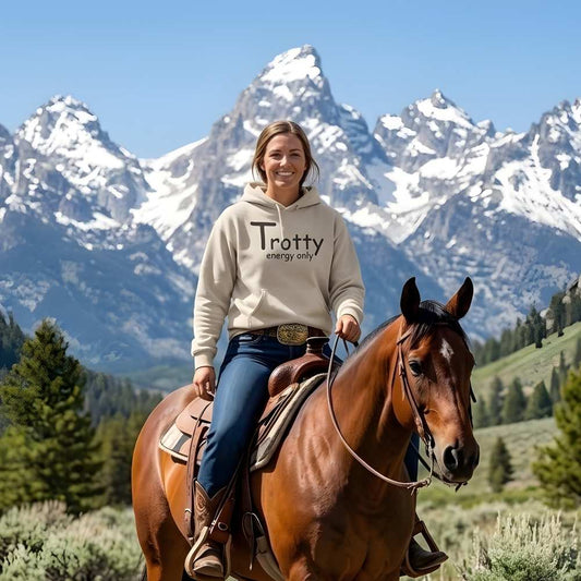 Person trail riding a horse with snow-capped mountains in the background. Trotty Energy Only Hoodie for Horse Riders, Cozy Equestrian Hoodie for Trail Riding and Barn, perfect gift for horse lovers, mothers day gift, fathers day gift, xmas gift