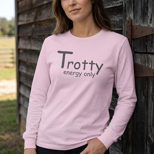 Person wearing a pink sweatshirt with 'Trotty energy only' text, standing against a wooden barn. Trotty Energy Only Long Sleeve Tee for Horse Lovers, Trail Riding Tee Equestrian Wear, perfect gift for horse riders, mothers day gift, fathers day gift, xmas gift