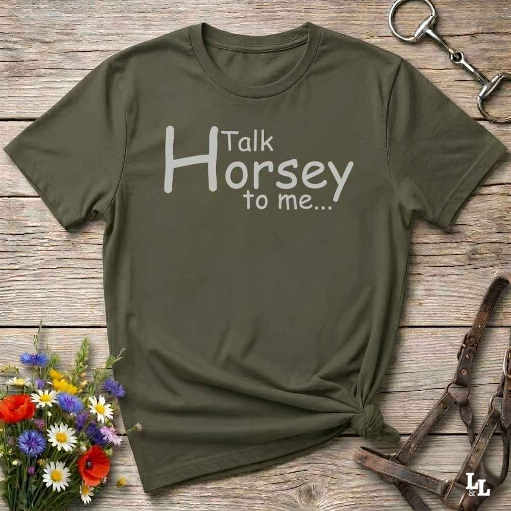 An olive green short-sleeve t-shirt with the white printed text 'Talk Horsey to me.