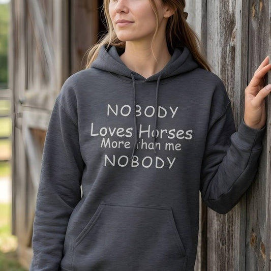 Person wearing a hoodie with text standing against a wooden barn. Nobody Loves Horses Like Me Hoodie for Horse Lovers, Trail Riding Hoodie. perfect present for horse riders, xmas gift for horse riders.
