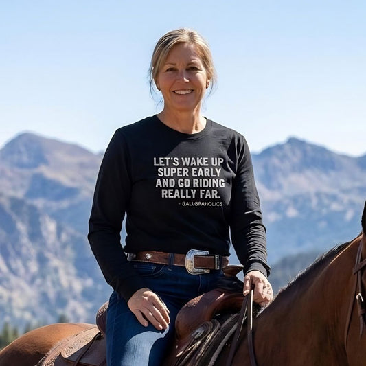 Woman riding a horse with mountains in the background, wearing a black sweatshirt with text. Let's Wake up Super Early Long Sleeve Tee Trail Riding Tee for Horse Riders. Perfect gift for horse lovers, birthday present for horse riders, mother's day gift for horse rider, father's day gift for horse rider, Xmas present for horse lover. Horse mom gifts. Horse dad gifts.
