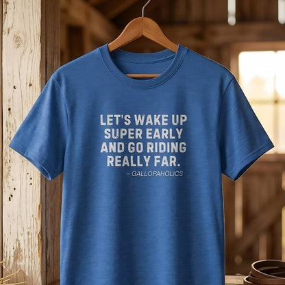 Blue t-shirt with text on a wooden hanger against a rustic background. Let's Wake Up Super Early T-Shirt for Horse Riders. Equestrian wear trail riding Tee. Perfect gift for horse lover, birthday present for horse rider, mother's day present, father's day present