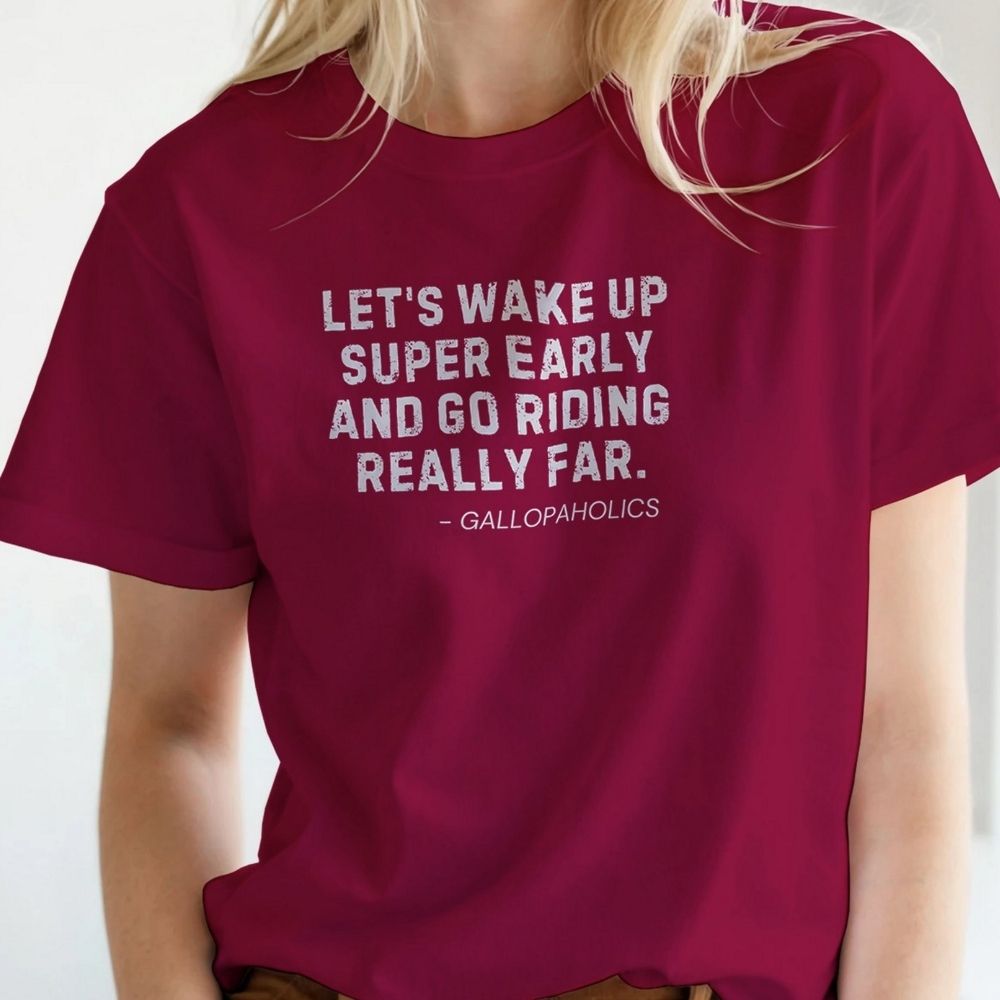 Maroon t-shirt with white text worn by a person on a plain background. Let's Wake Up Super Early T-Shirt for Horse Riders. Equestrian wear trail riding Tee. Perfect gift for horse lover, birthday present for horse rider, mother's day present, father's day present