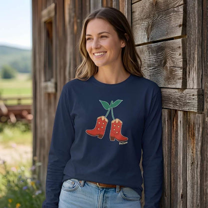 Woman wearing a navy blue sweatshirt with a graphic design, standing against a wooden barn outdoors. Cherry Cowboy Boots Long Sleeve Tee for Horse Lovers, Trail Riding Tee, horse girl shirt, horse mom shirt, horse lover, horse girl, Funny horse lover gifts, Funny horse shirts, Horse girl gifts, Equestrian graphic tees, fathers day gift, Sarcastic horse shirt
