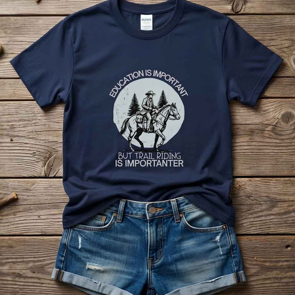 Navy blue t-shirt with graphic design and text on a wooden surface, paired with denim shorts. Education is Important T-Shirt for Horse Lovers, Equestrian Wear Short Tee, horse girl shirt, horse mom shirt, horse lover, horse girl, Funny horse lover gifts, Funny horse shirts, Horse girl gifts, Equestrian graphic tees, fathers day gift, Sarcastic horse shirt