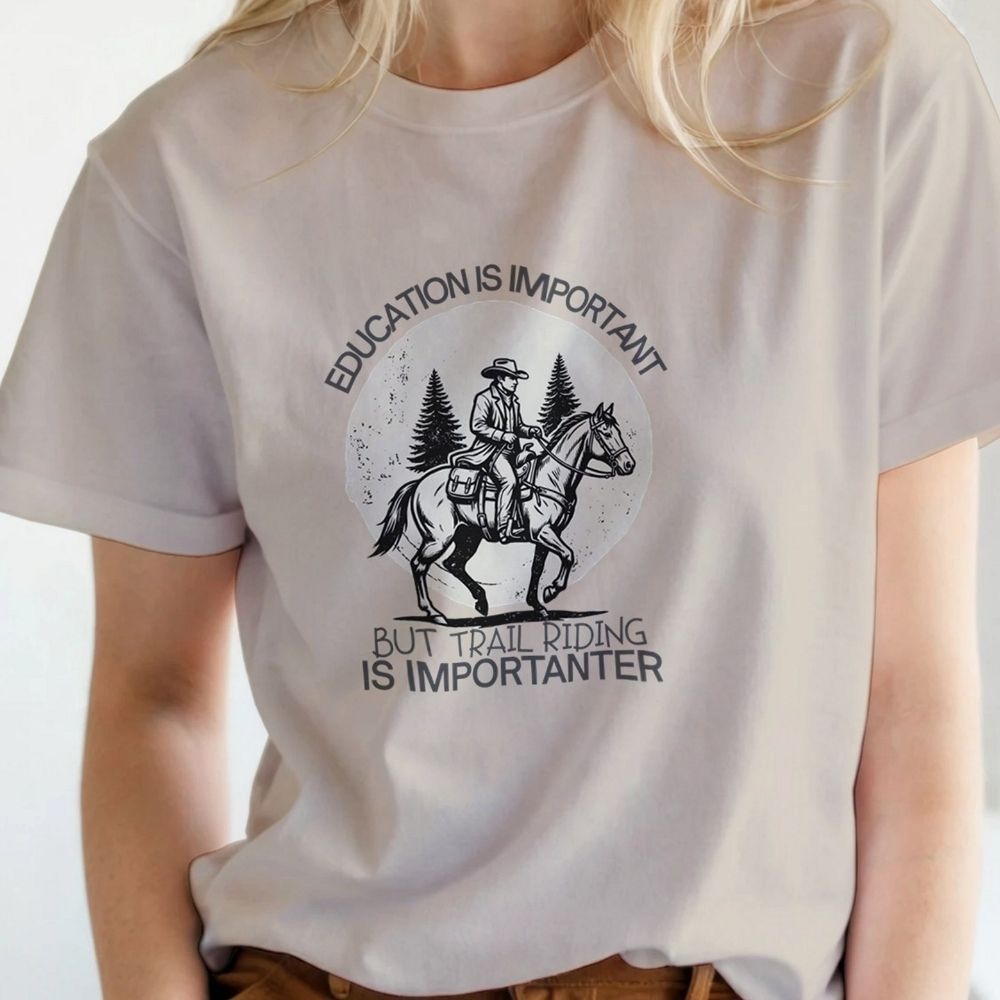 Person wearing a white t-shirt with a graphic and text about trail riding. Education is Important T-Shirt for Horse Lovers, Equestrian Wear Short Tee, horse girl shirt, horse mom shirt, horse lover, horse girl, Funny horse lover gifts, Funny horse shirts, Horse girl gifts, Equestrian graphic tees, fathers day gift, Sarcastic horse shirt