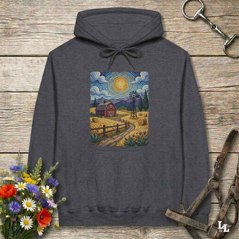 Gray hoodie with a farm scene print on a wooden surface with flowers and horse equipment. Gogh to the Barn.