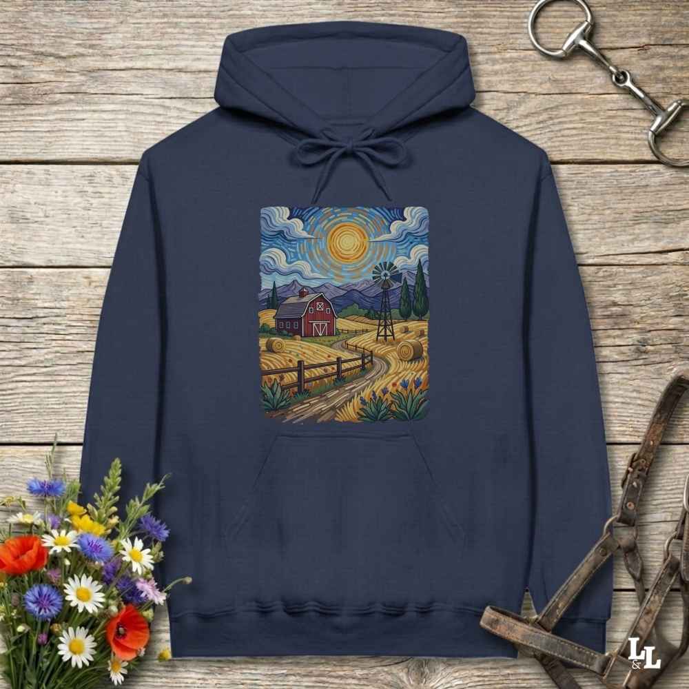Navy blue hoodie with a farm scene print on a wooden surface with flowers and horse equipment. Gogh to the Barn.