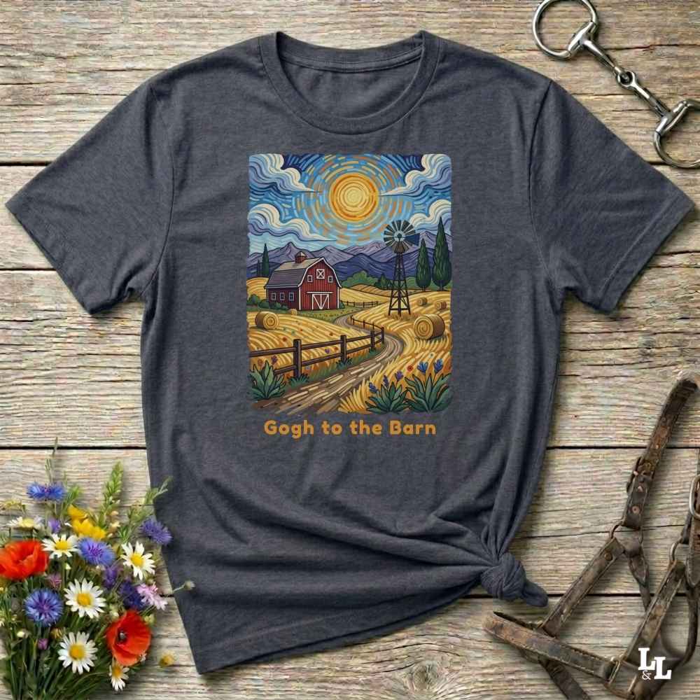 A flat lay mockup of a gray t-shirt featuring Van Gogh-inspired landscape art of a farm, with a red barn, windmill, and hay bales under a swirling sun. Below the image, orange text reads, 'Gogh to the Barn.' Ideal horse lover and barn life gift.