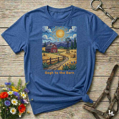 A flat lay mockup of a blue  t-shirt featuring Van Gogh-inspired landscape art of a farm, with a red barn, windmill, and hay bales under a swirling sun. Below the image, orange text reads, 'Gogh to the Barn.' Ideal horse lover and barn life gift.