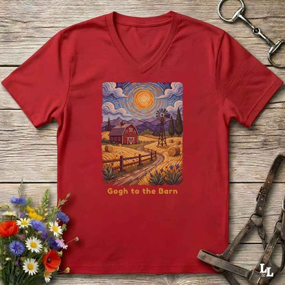 red V-neck t-shirt laid flat on a rustic wooden surface, featuring a colorful Van Gogh-inspired barn scene graphic with the text 'Gogh to the Barn'. The shirt is styled with equestrian props (reins and a bit) and a small bouquet of wildflowers.