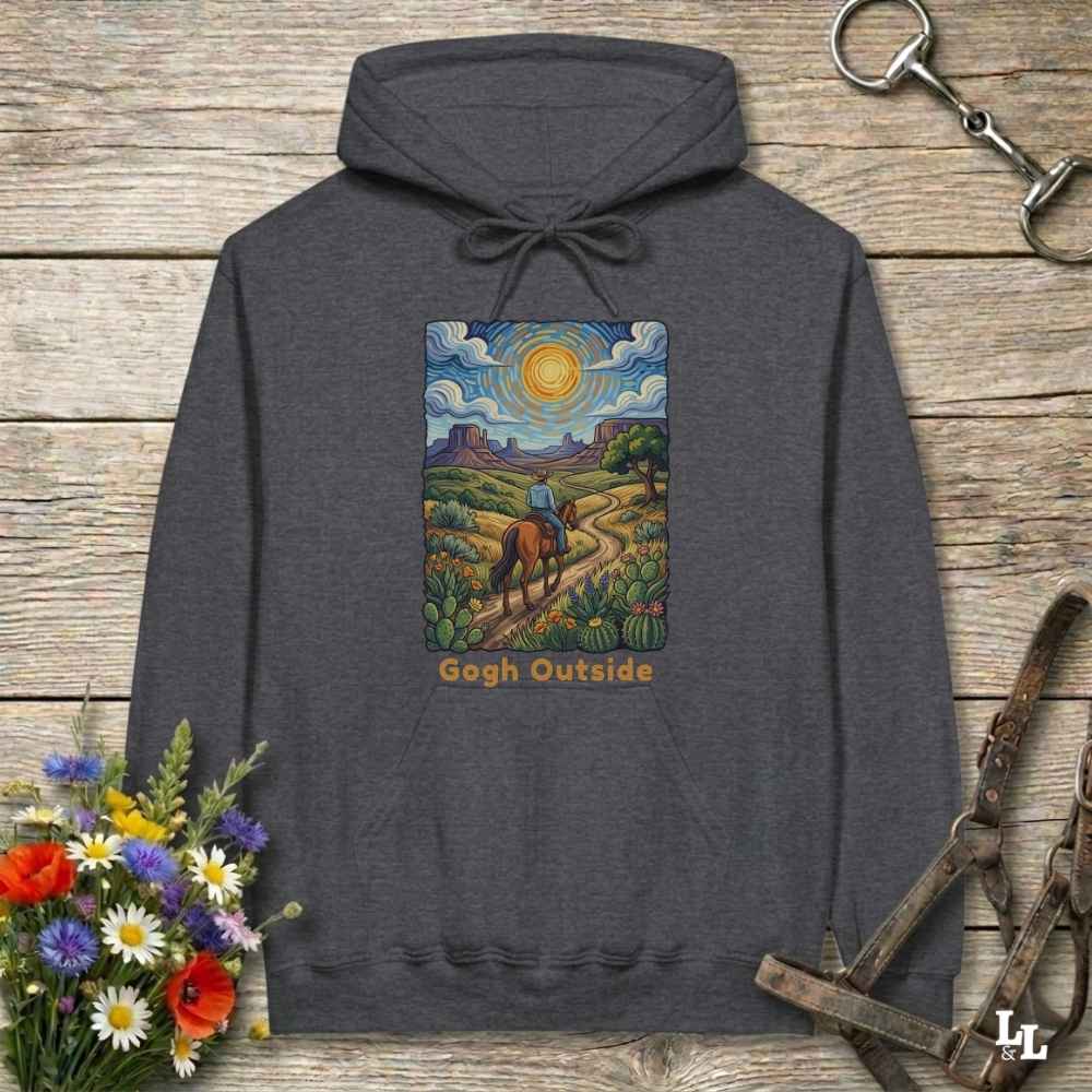 gray Hoodie, Gogh Outside graphic design,  lying on wooden floor with equestrian halter and horse bit
