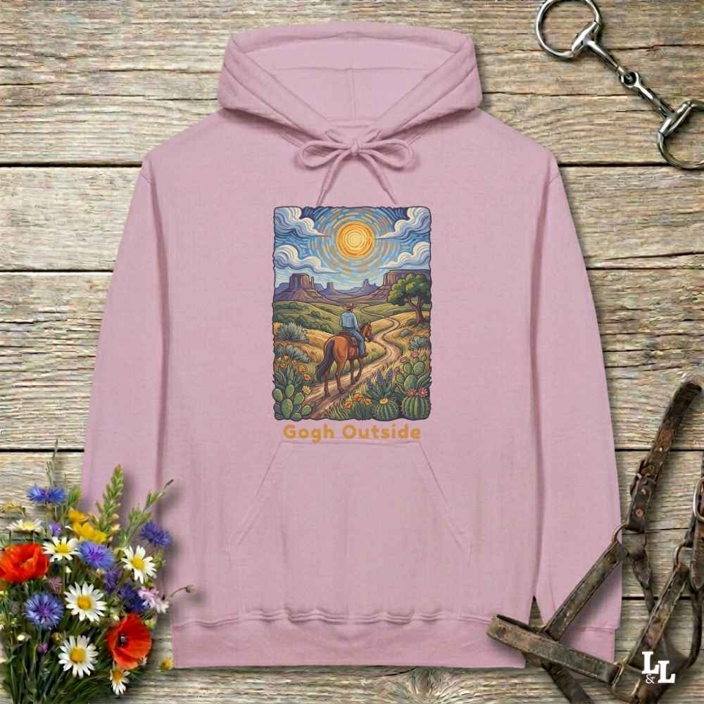 pink Hoodie, Gogh Outside graphic design,  lying on wooden floor with equestrian halter and horse bit