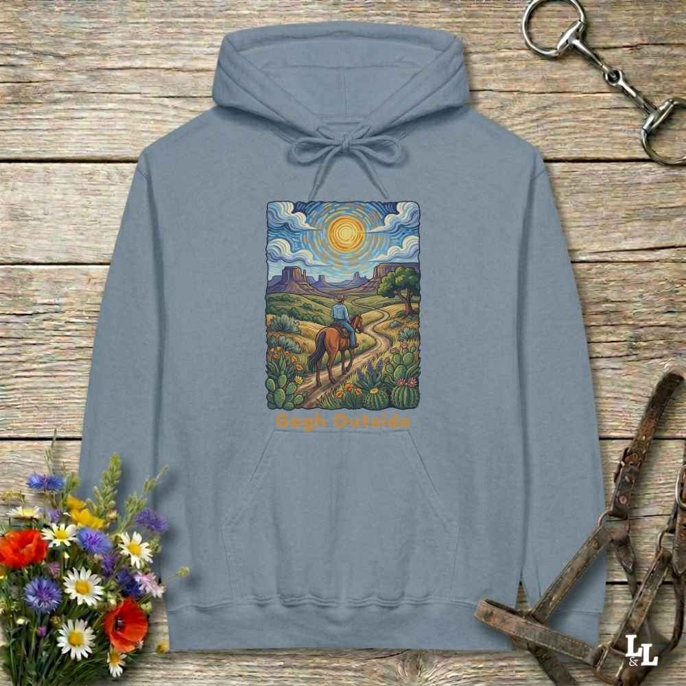 blue Hoodie, Gogh Outside graphic design,  lying on wooden floor with equestrian halter and horse bit