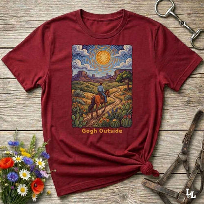 red t-shirt with a desert scene graphic and 'Gogh Outside' text on a wooden surface with flowers and a key. Perfect gift for horse lovers.